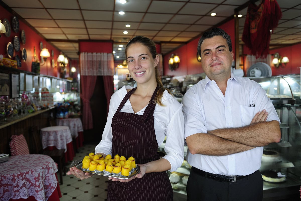 Small Business: Owner Of A Cafe And Waitress small business: owner of a cafe and waitress with pastry