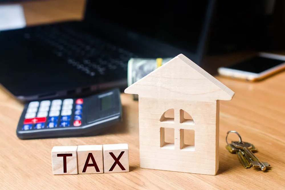 bigstock-Small-Wooden-House-And-Taxes-O-251701360