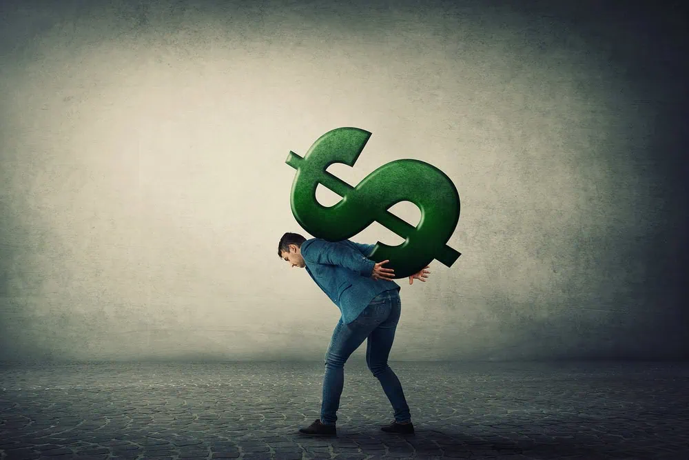 bigstock-Businessman-Carrying-A-Big-Ame-339438133