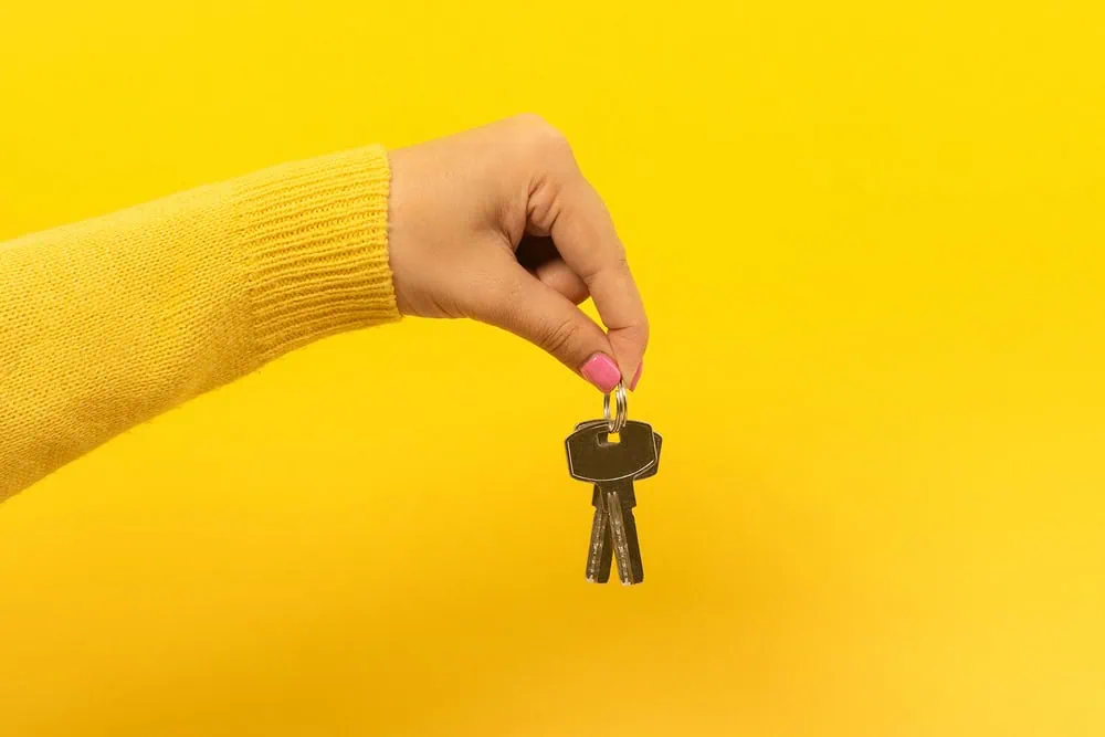 bigstock-Female-Hand-Holding-House-Keys-336518146